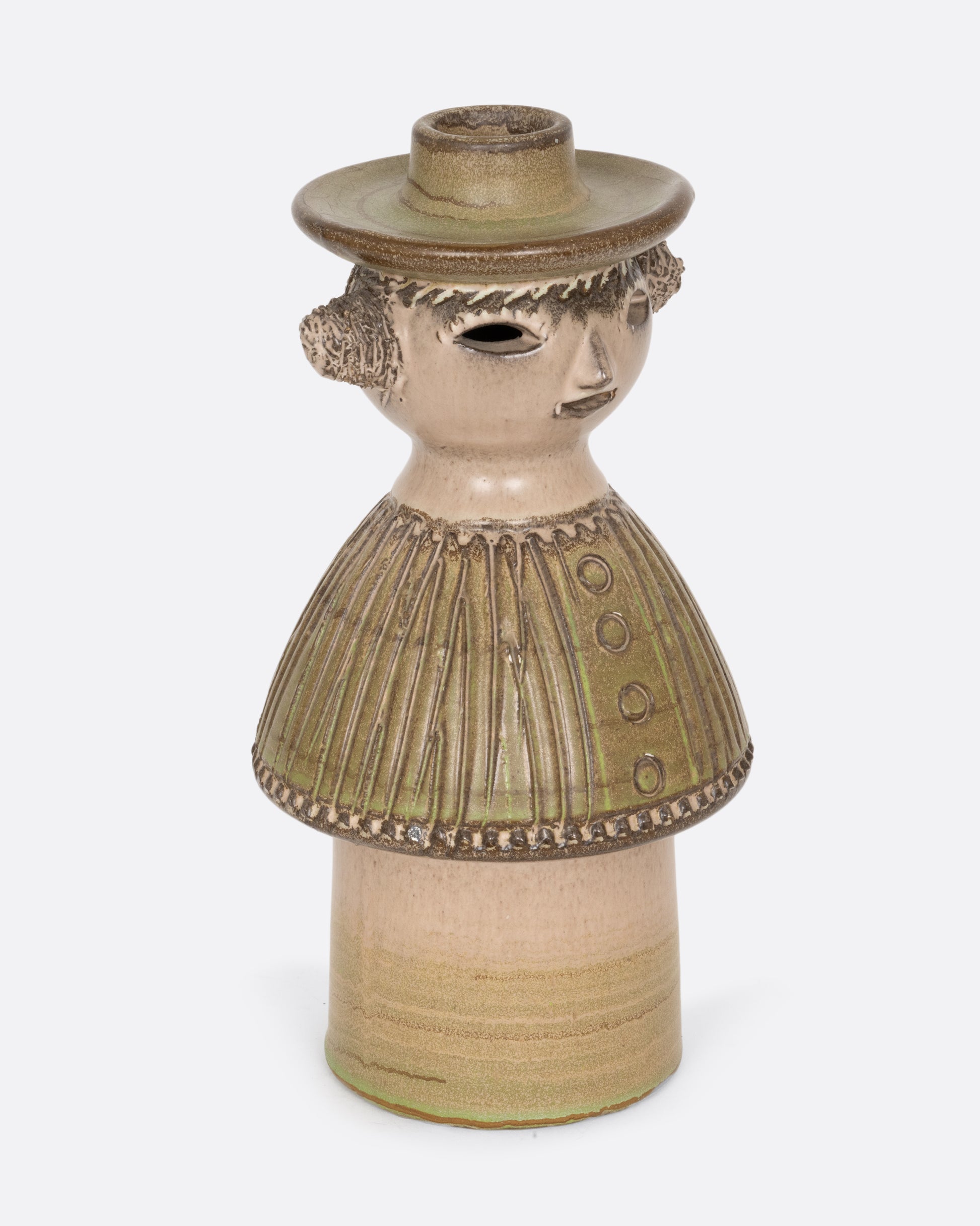 A ceramic person with a candlestick holder hat wearing a textured green outfit. Shown from the side.