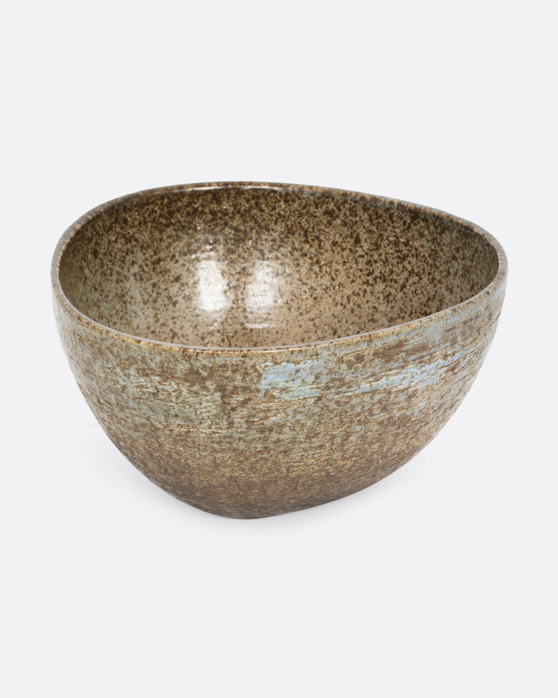 A rounded triangular ceramic bowl with tones in earthy green, brown, and light blue. Shown from the side.