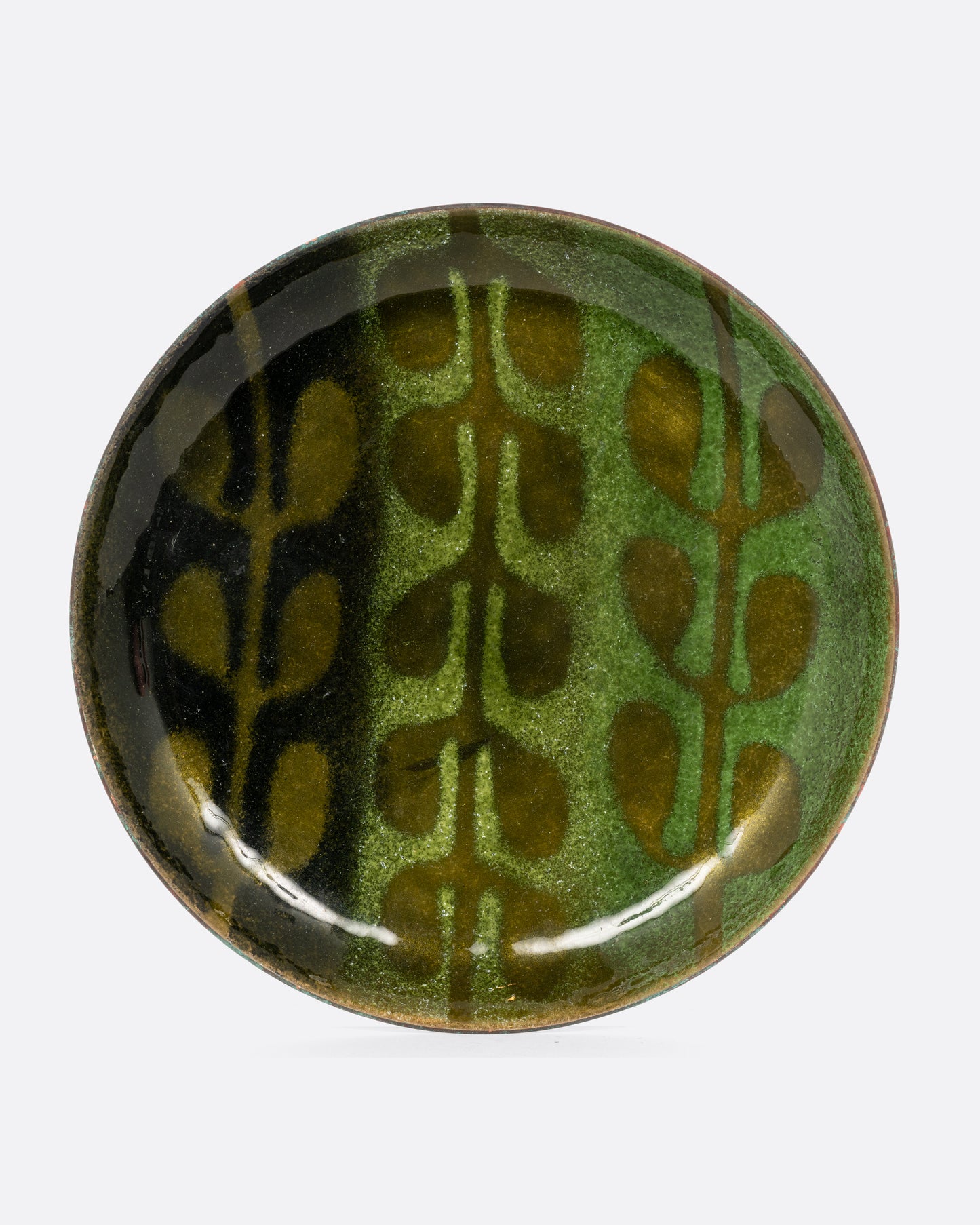 A small gradient green enameled metal plate with a leaf motif. Shown from the front.