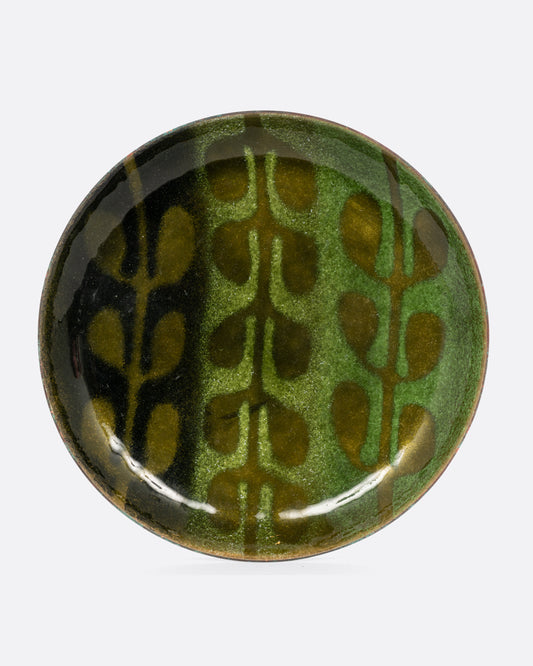 A small gradient green enameled metal plate with a leaf motif. Shown from the front.