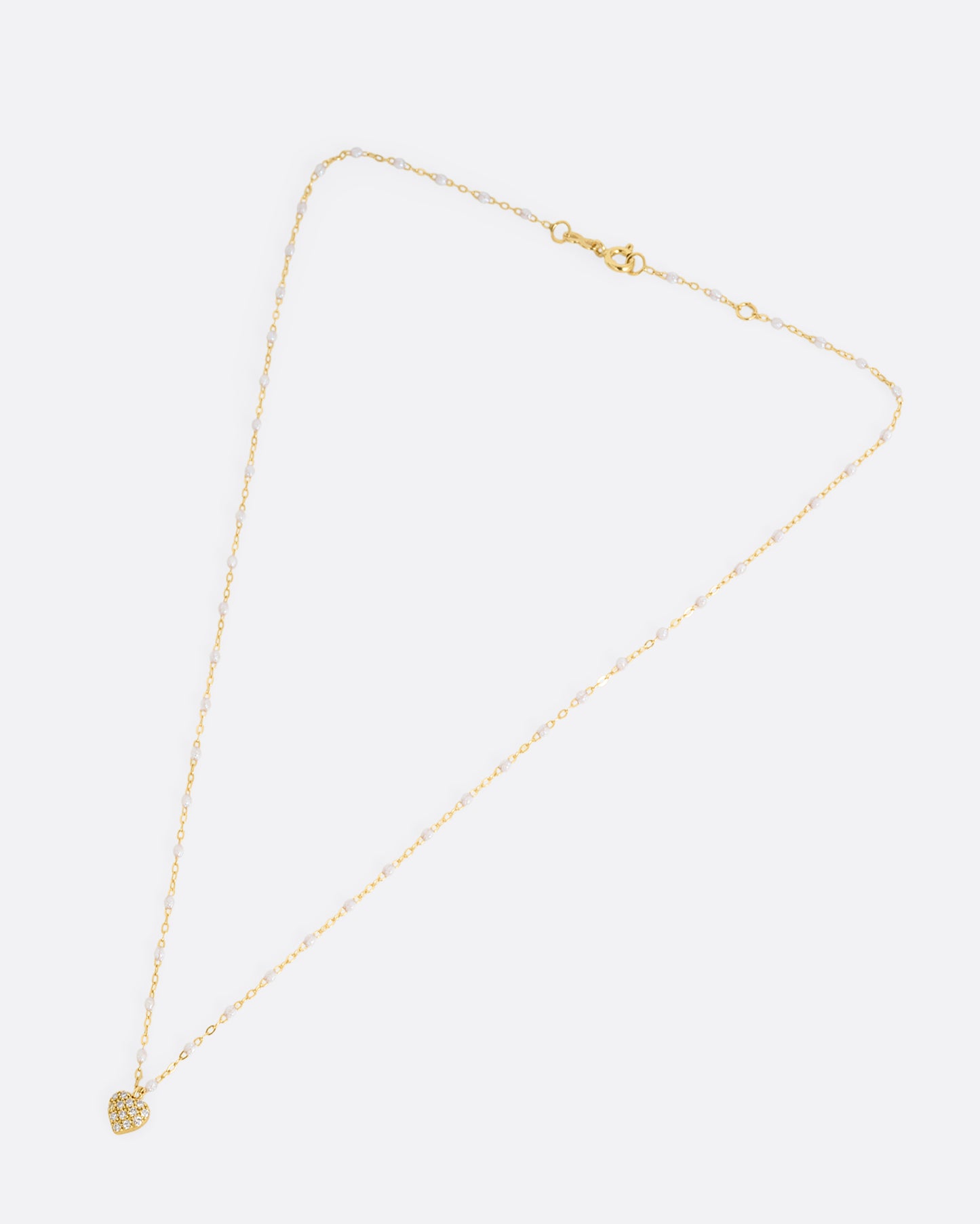 yellow gold necklace with resin and diamond heart charm shown horizontally