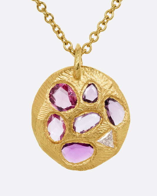 yellow gold necklace with pink sapphire pendant shown from the front