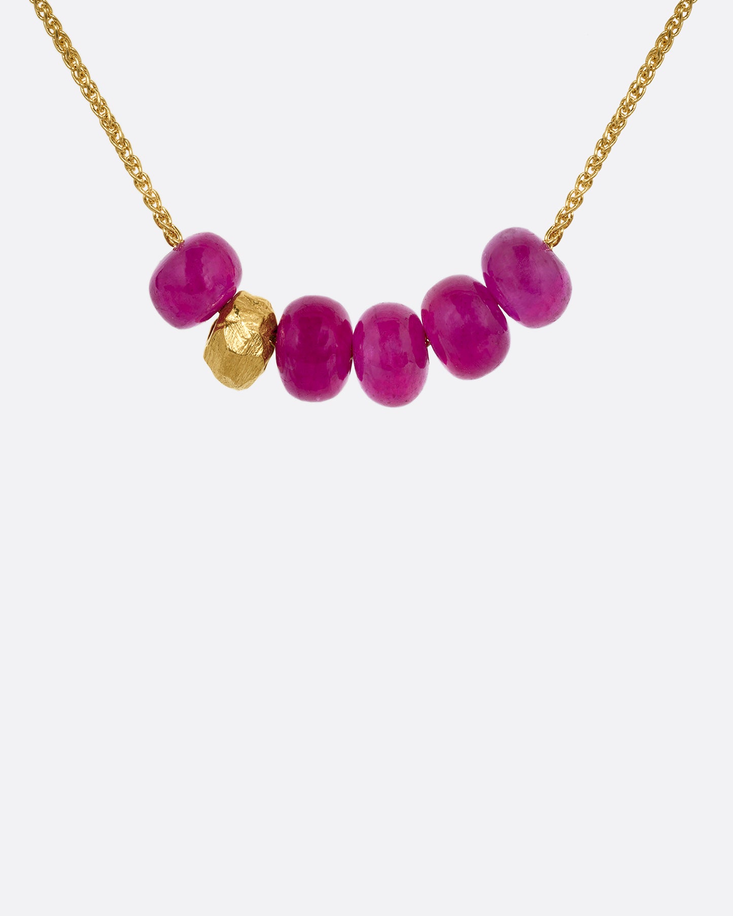 yellow gold necklace with beaded rubies shown from the front
