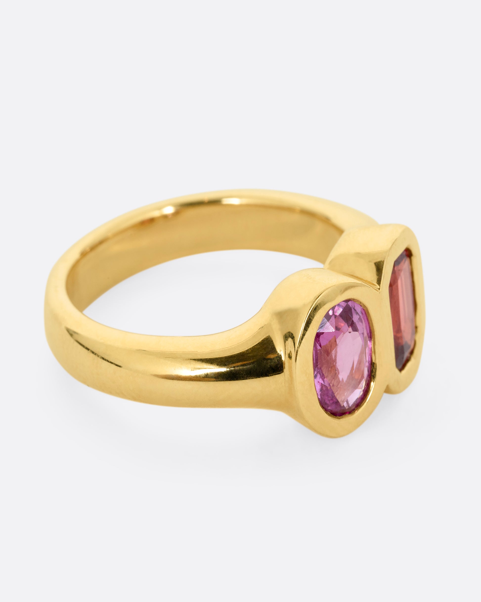 yellow gold ring with red and orange sapphires shown from the other side