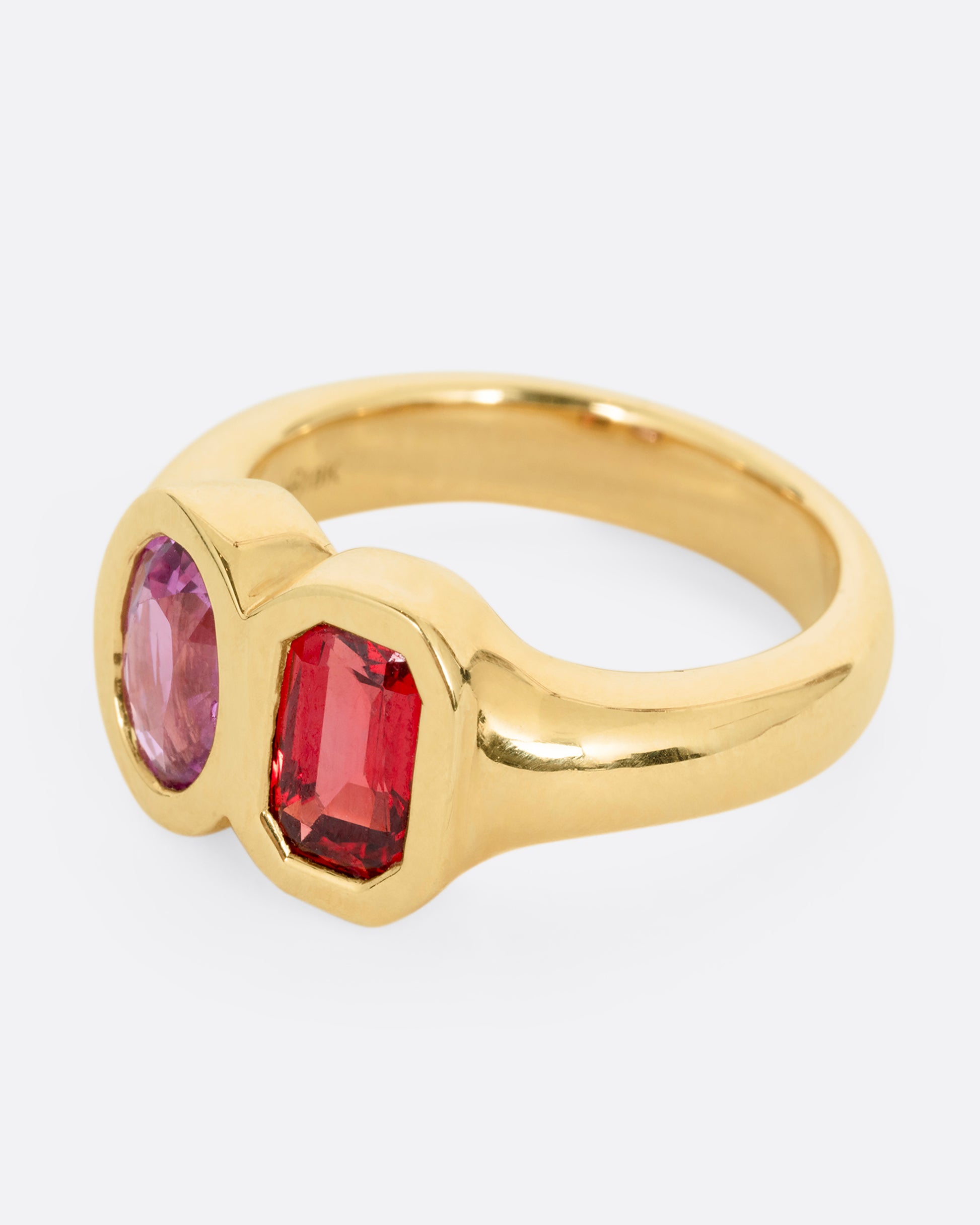 yellow gold ring with red and orange sapphires shown from the side