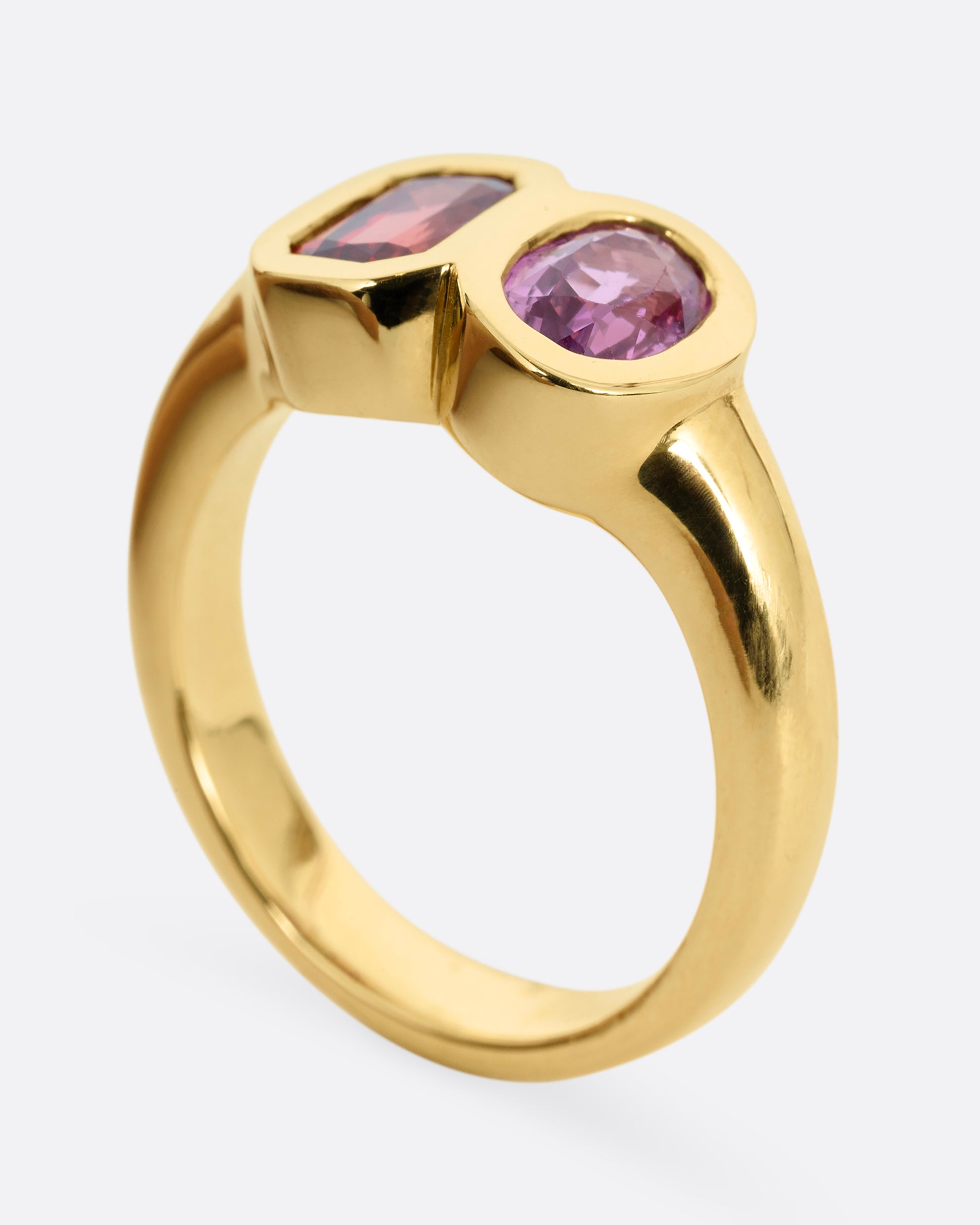 yellow gold ring with red and orange sapphires shown upright
