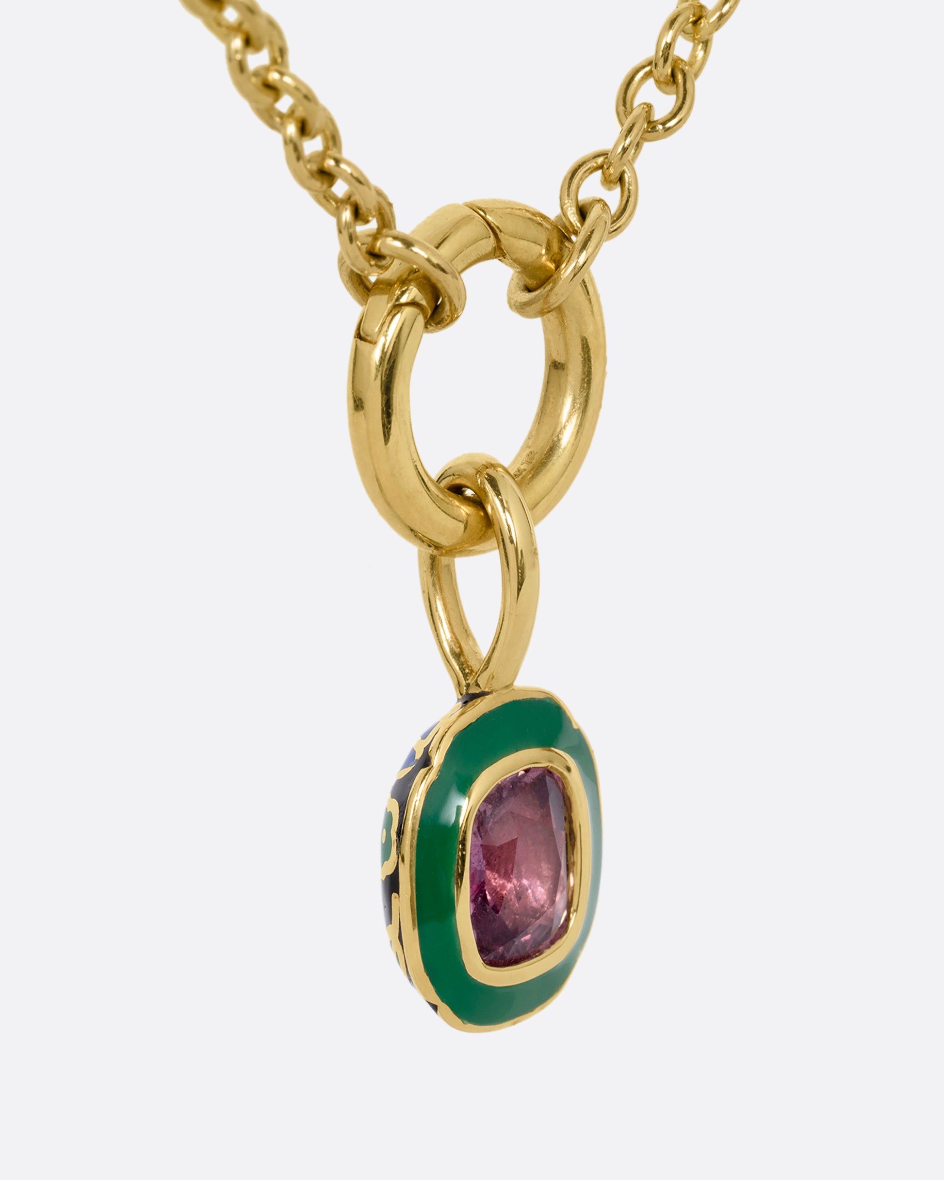 yellow gold pink sapphire pendant with enamel shown from the side