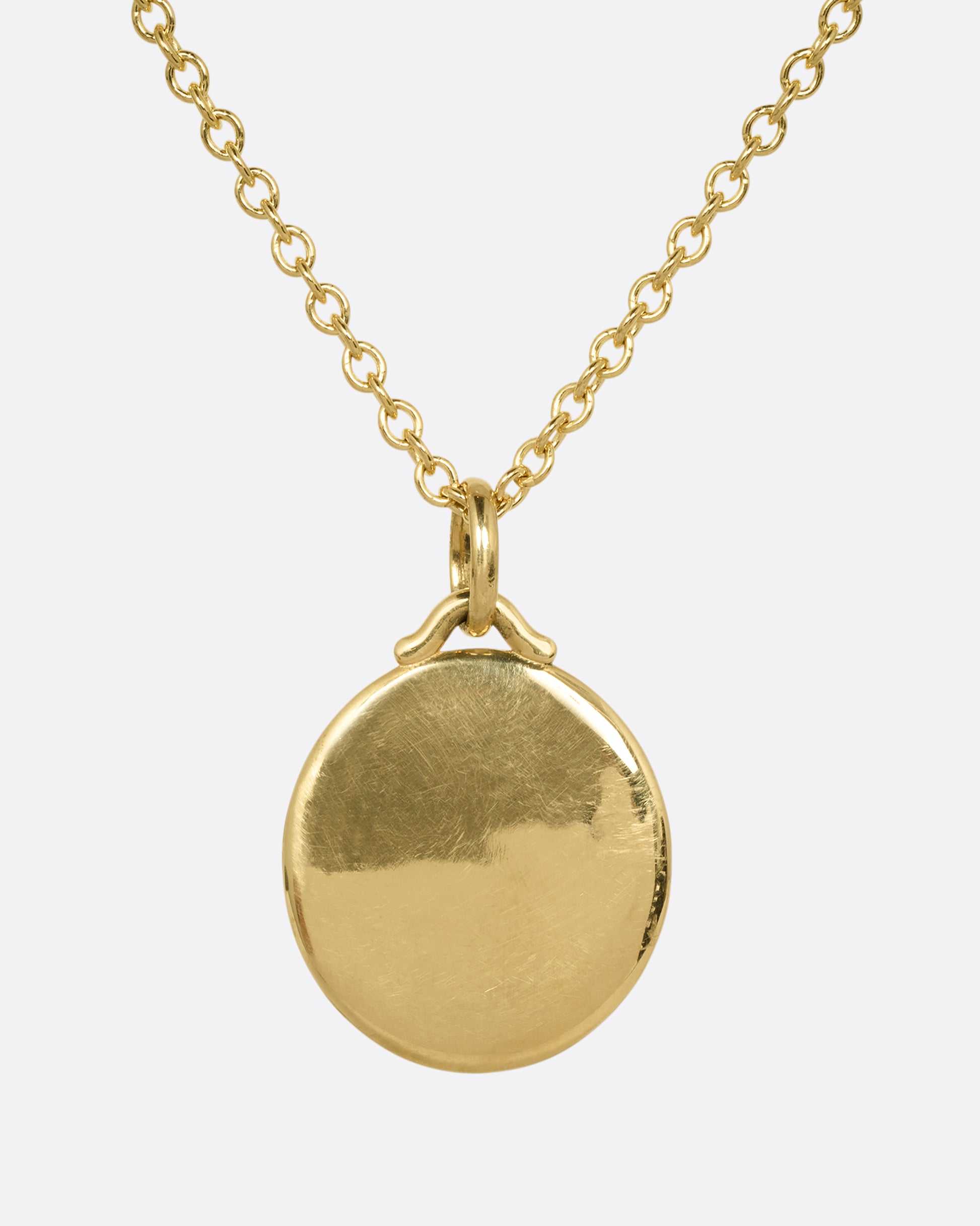 A yellow gold pendant on a  cable chain. Shown from the back.