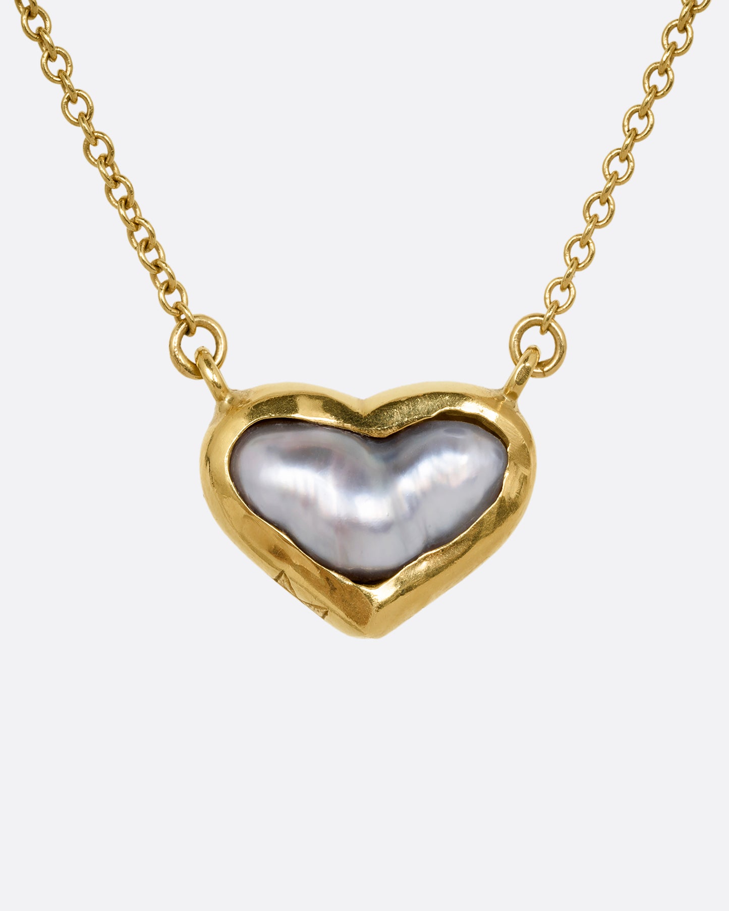 yellow gold necklace with a heart shaped pearl from the front