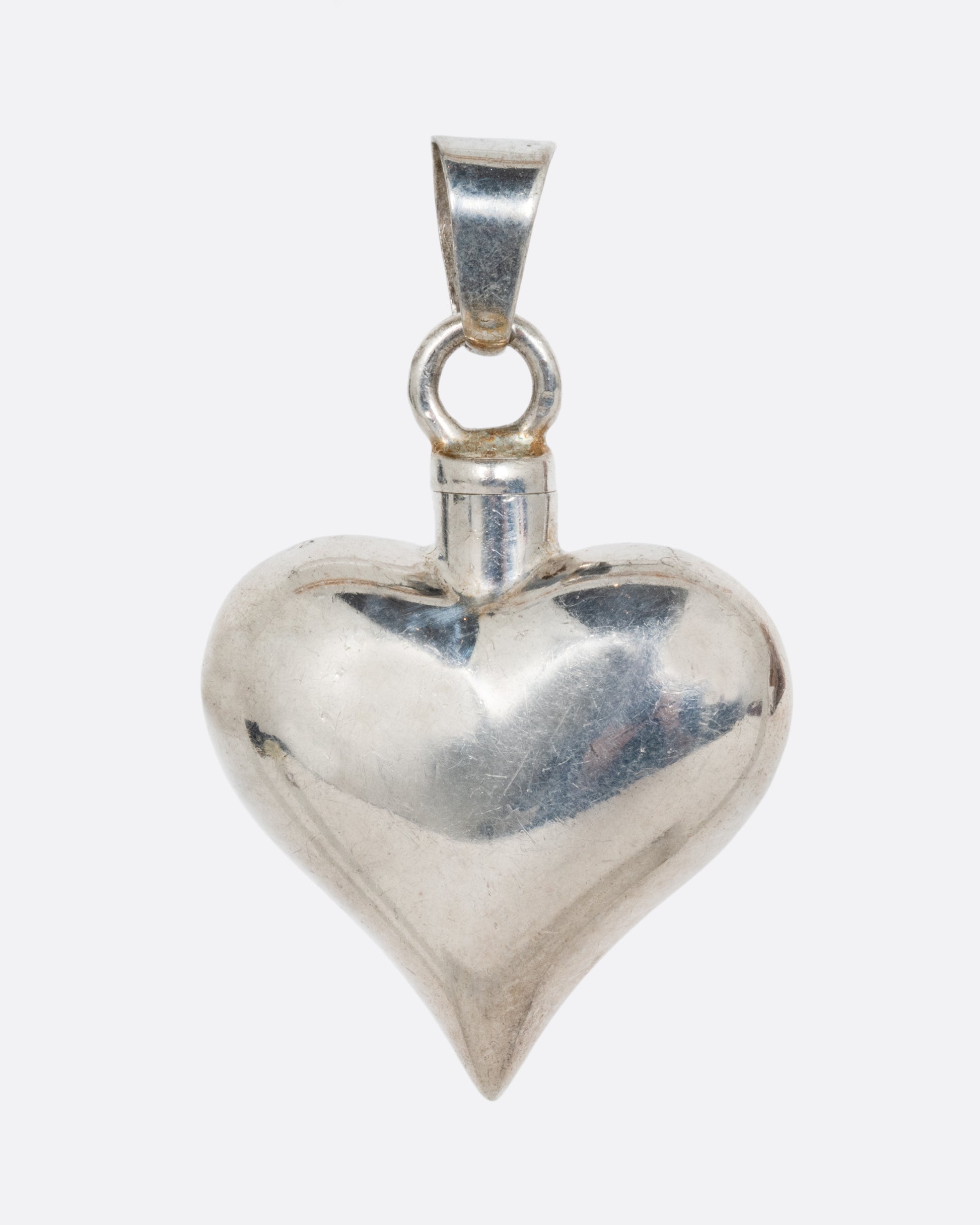 vintage sterling silver heart shaped perfume bottle shown from the front 