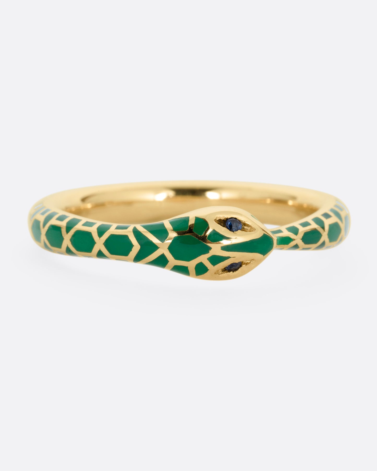 A yellow gold  ouroboros ring with sapphire eyes and a green enamel snake skin pattern, shown from the front.