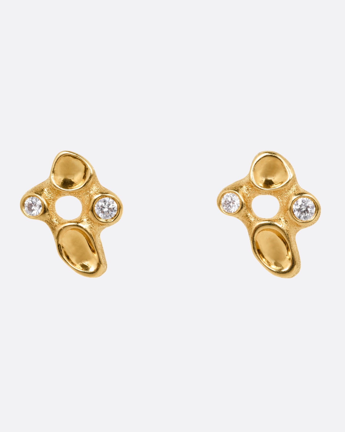 A pair of yellow gold cluster stud earrings with diamonds and smooth depressions, shown from the front.