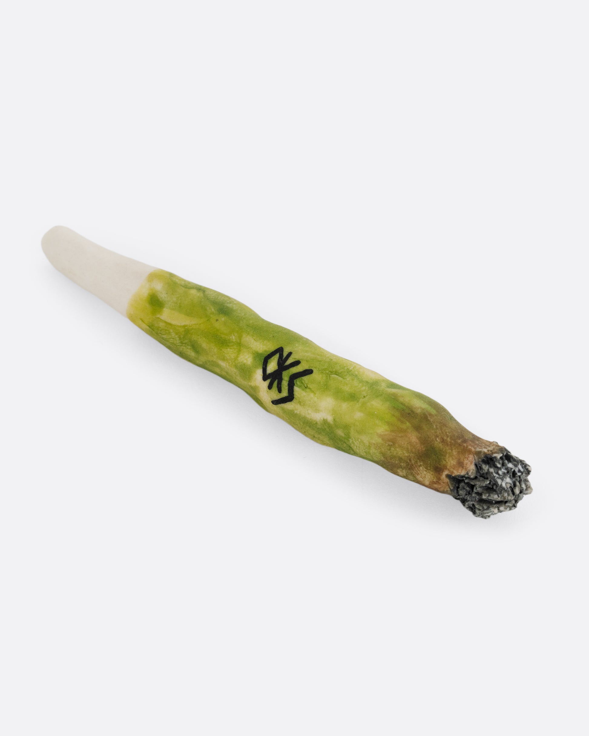 A porcelain joint painted to look like the real thing. Signed by the artist. Shown from the side.