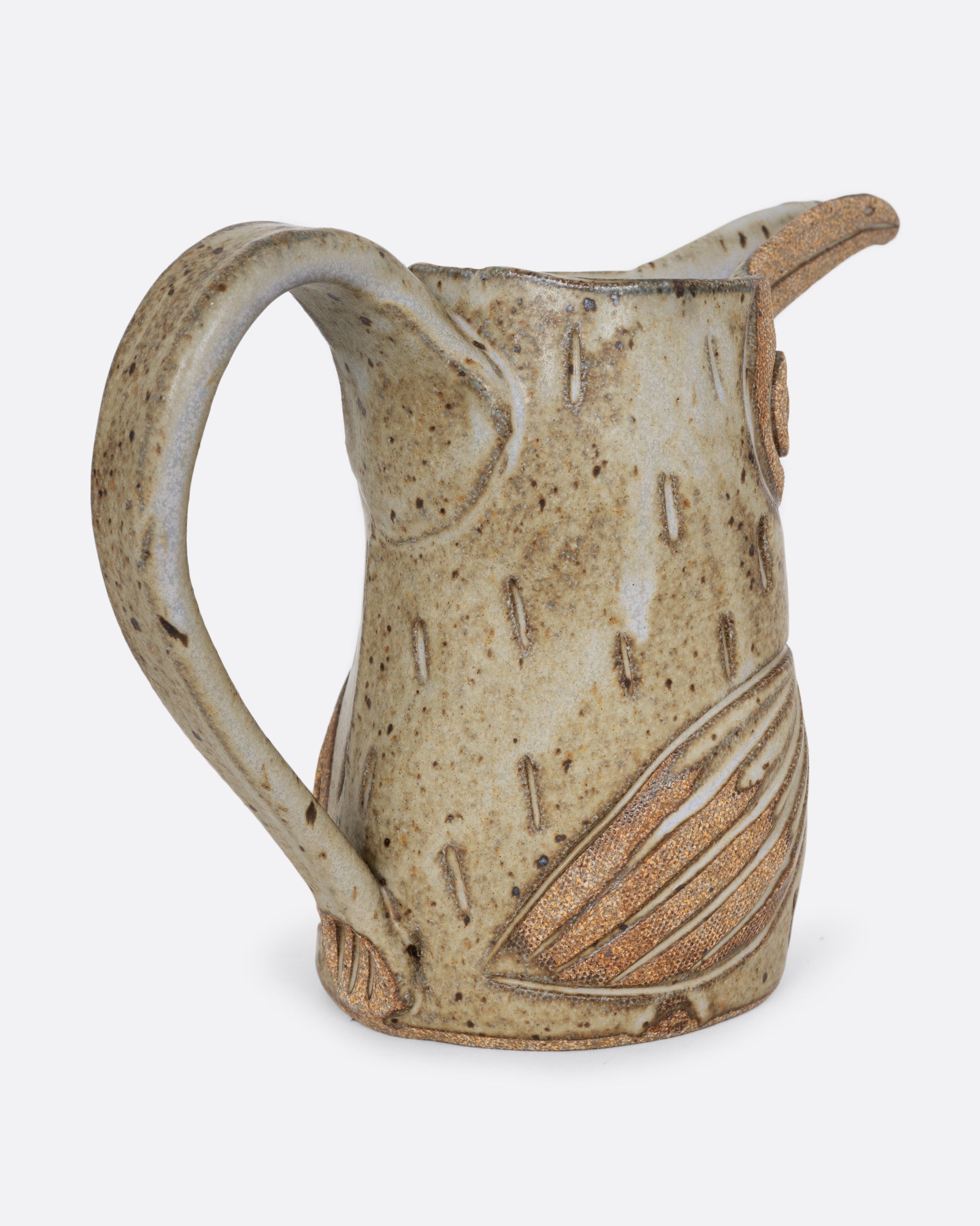 A toucan shaped pitcher with a handle. Shown from the back.