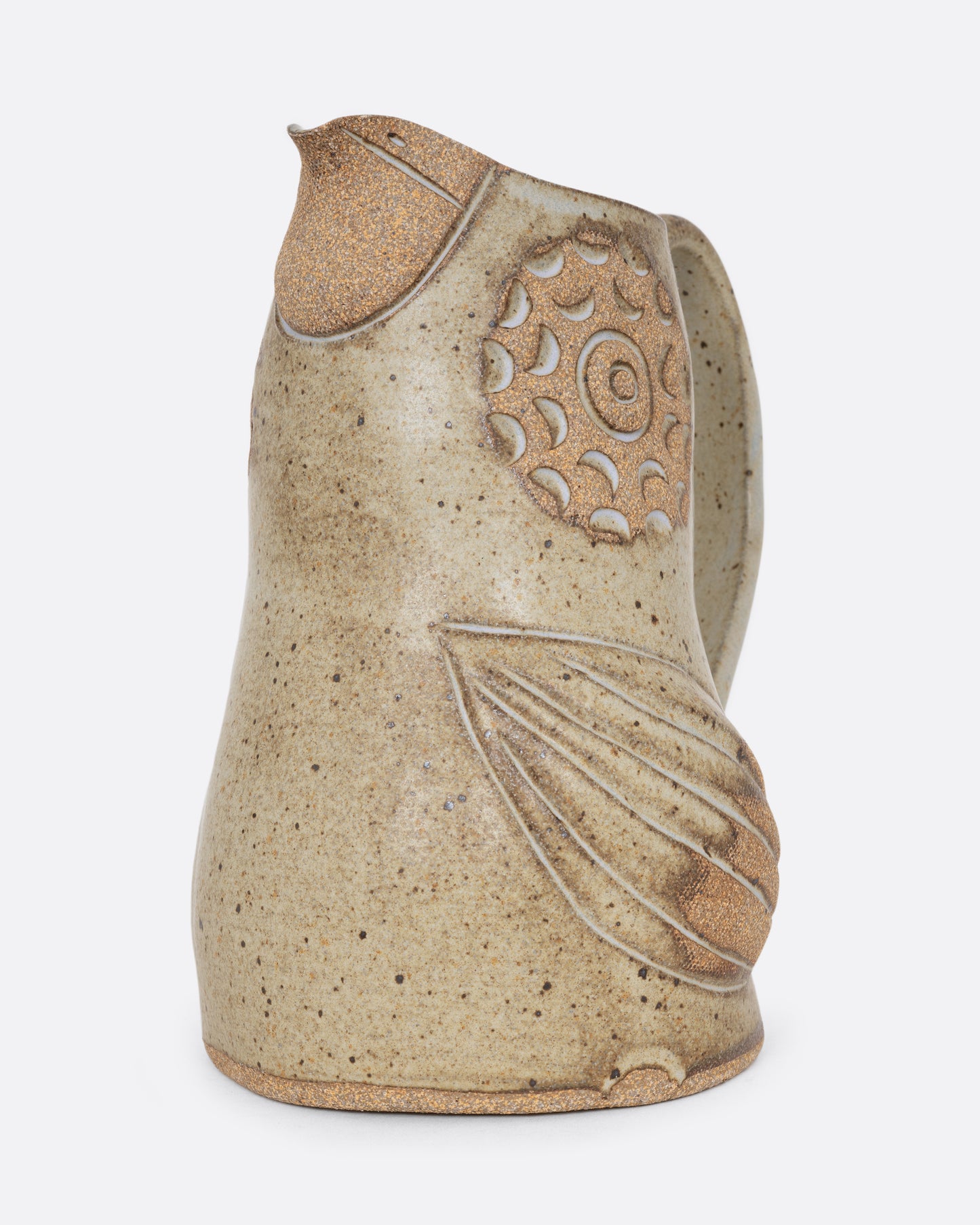 A bird shaped pitcher with a handle. Shown from the side diagonally.