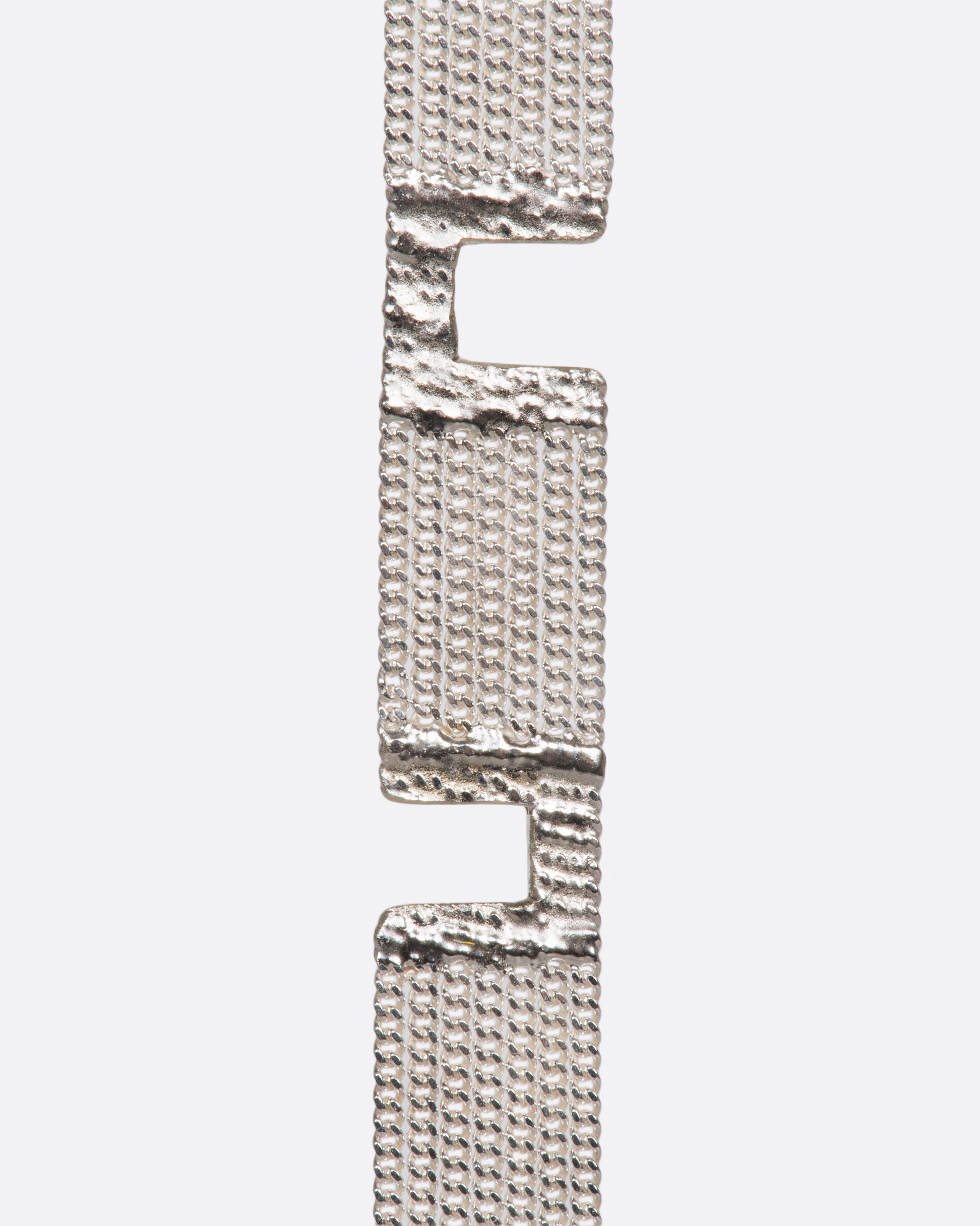A sterling silver multi-strand chain bracelet with alternating pattern finished with silver solder.