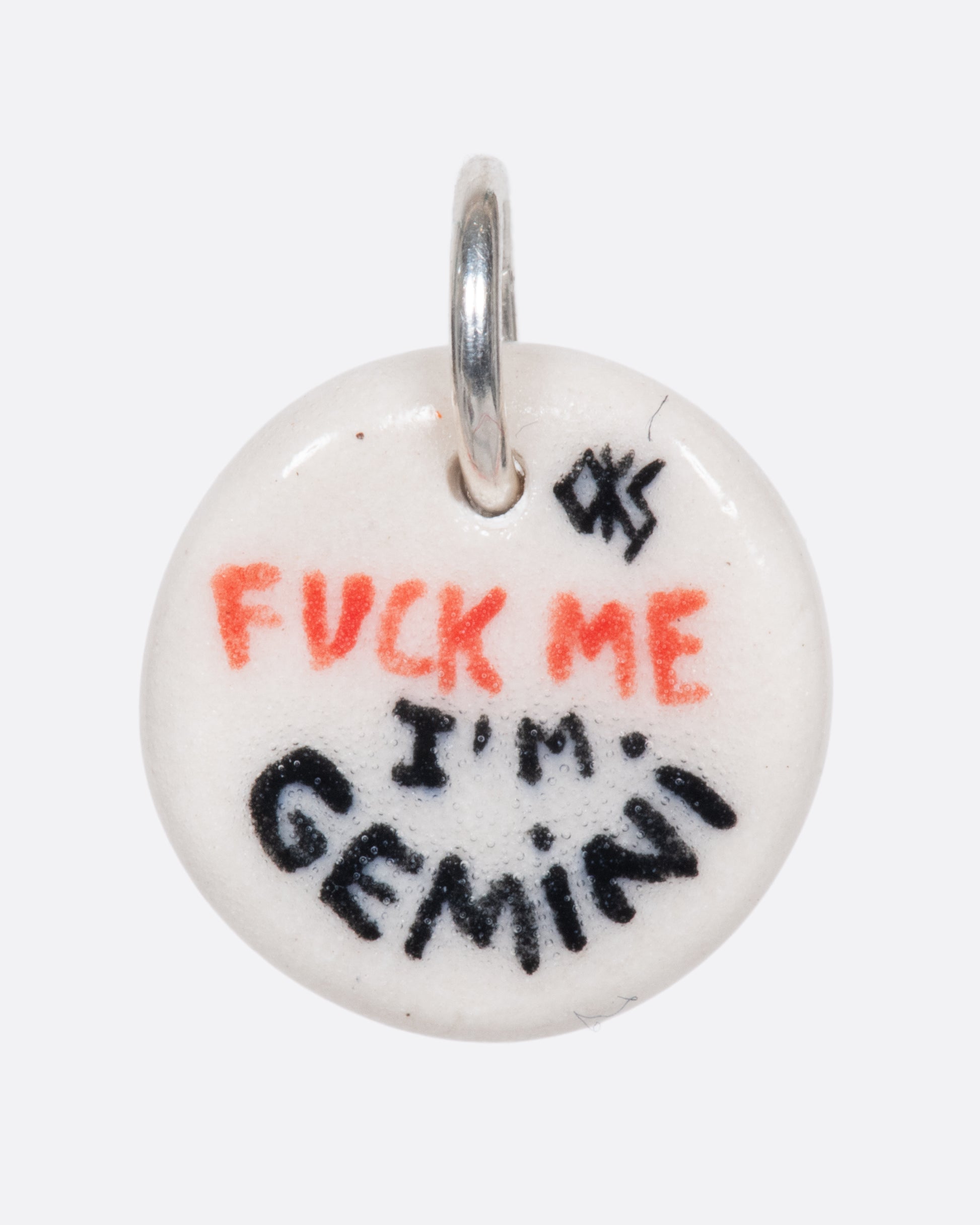 A handmade and painted porcelain zodiac disc charm with a sterling silver bail, featuring a sex position specific to each zodiac.