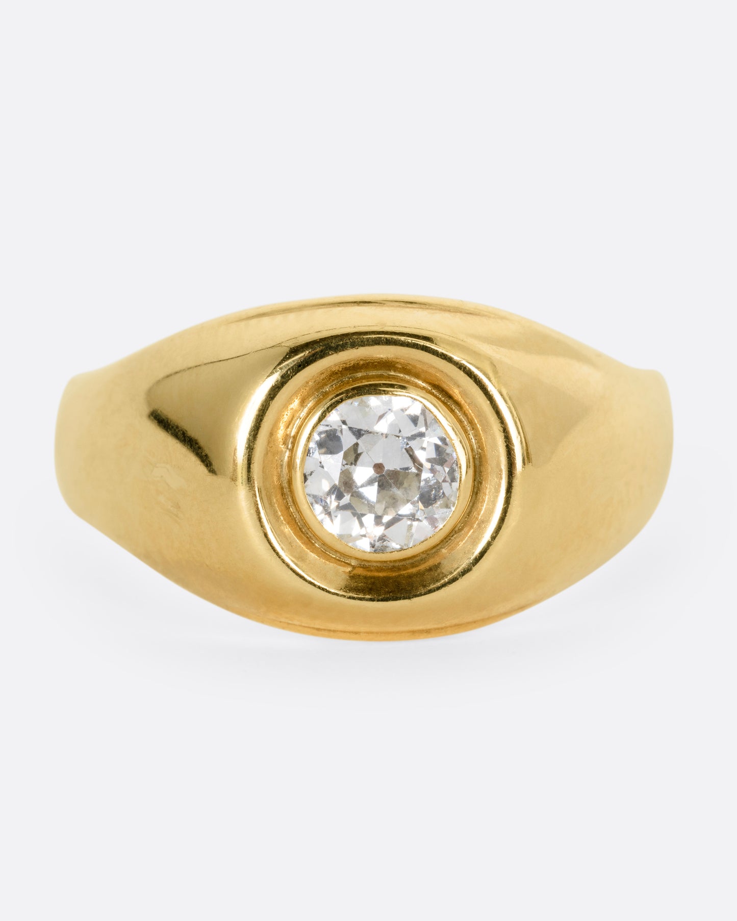 A yellow gold ring with a bezel set Old European Cut diamond. Shown from the front.