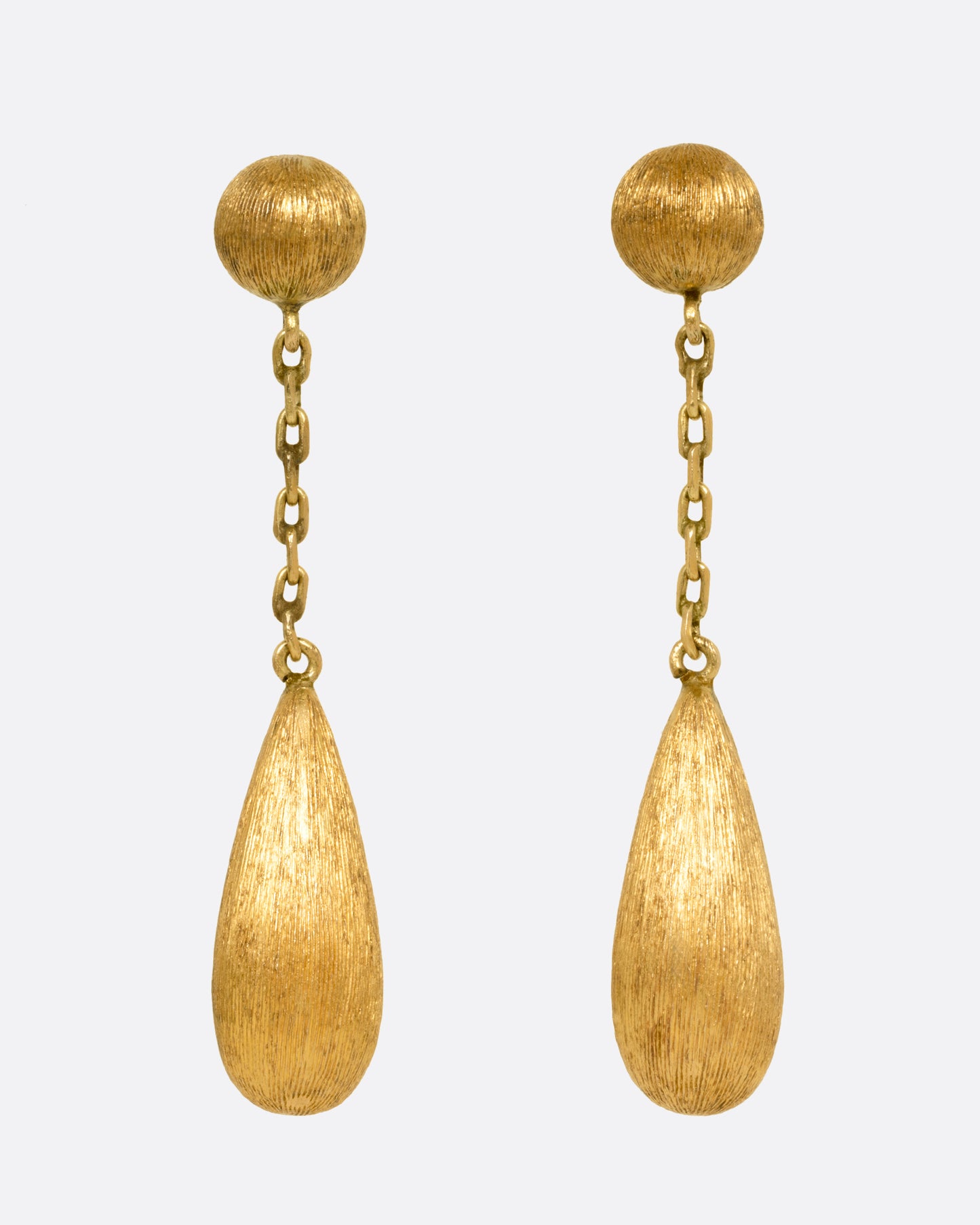 A pair of yellow gold teardrop shaped earrings, shown from the front.