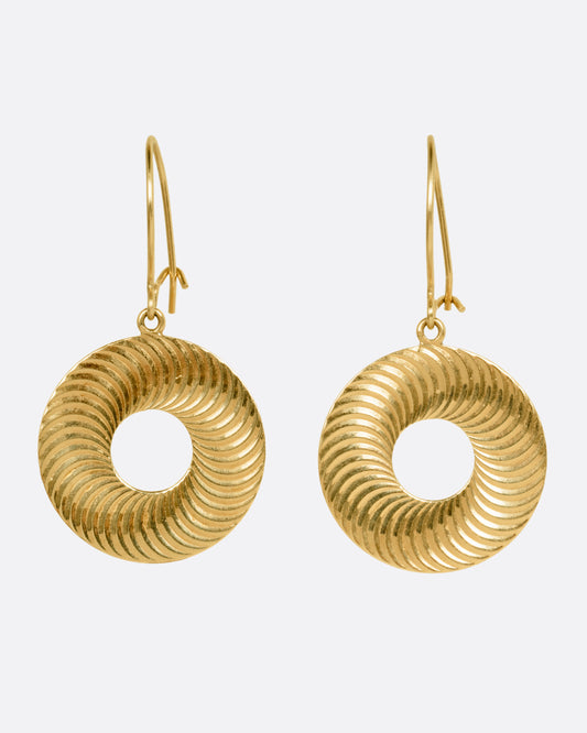 A pair of round yellow gold drop earrings with open centers and an illusional pattern, shown from the front.