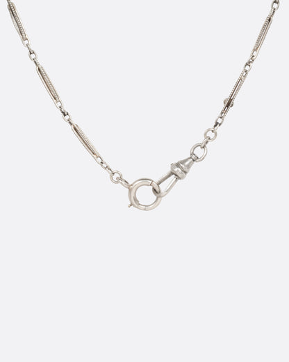 Vintage necklace in 10k white gold, long engraved bar links with red and black enamel stations and a spring ring clasp