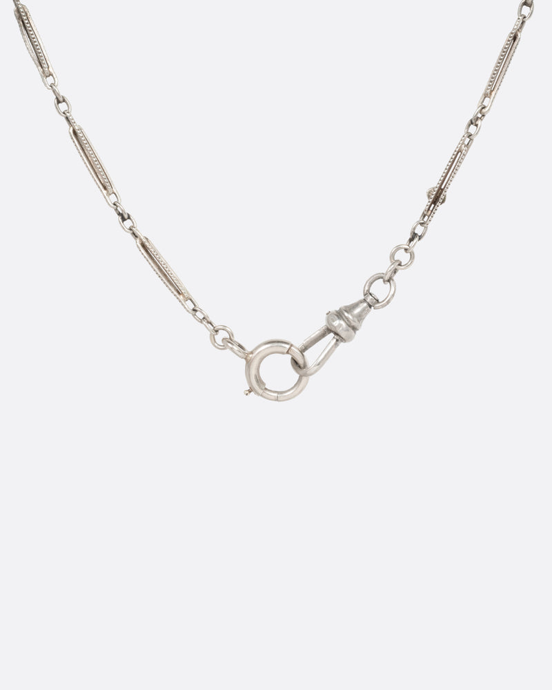 Vintage necklace in 10k white gold, long engraved bar links with red and black enamel stations and a spring ring clasp