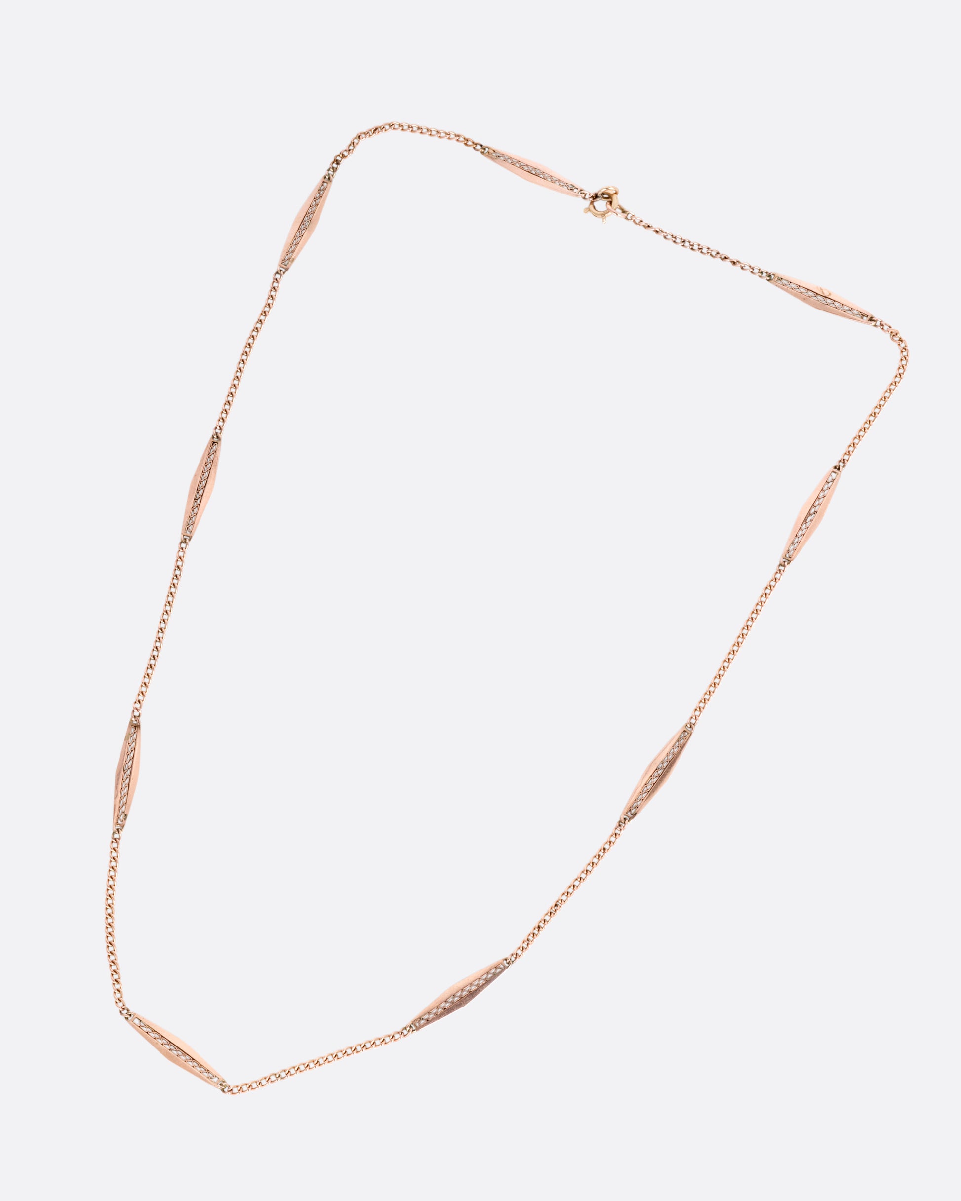 A rose gold bar link necklace shown from the front.