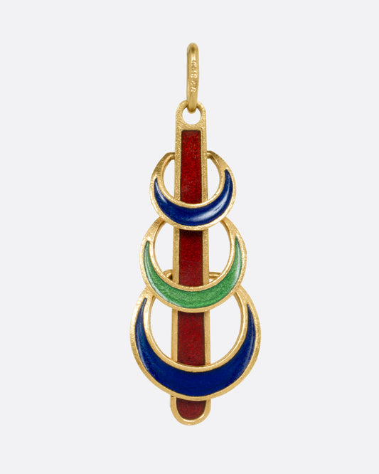 A yellow gold pendant with  three enamel crescents in blue and green on a red enamel bar. Shown from the front.