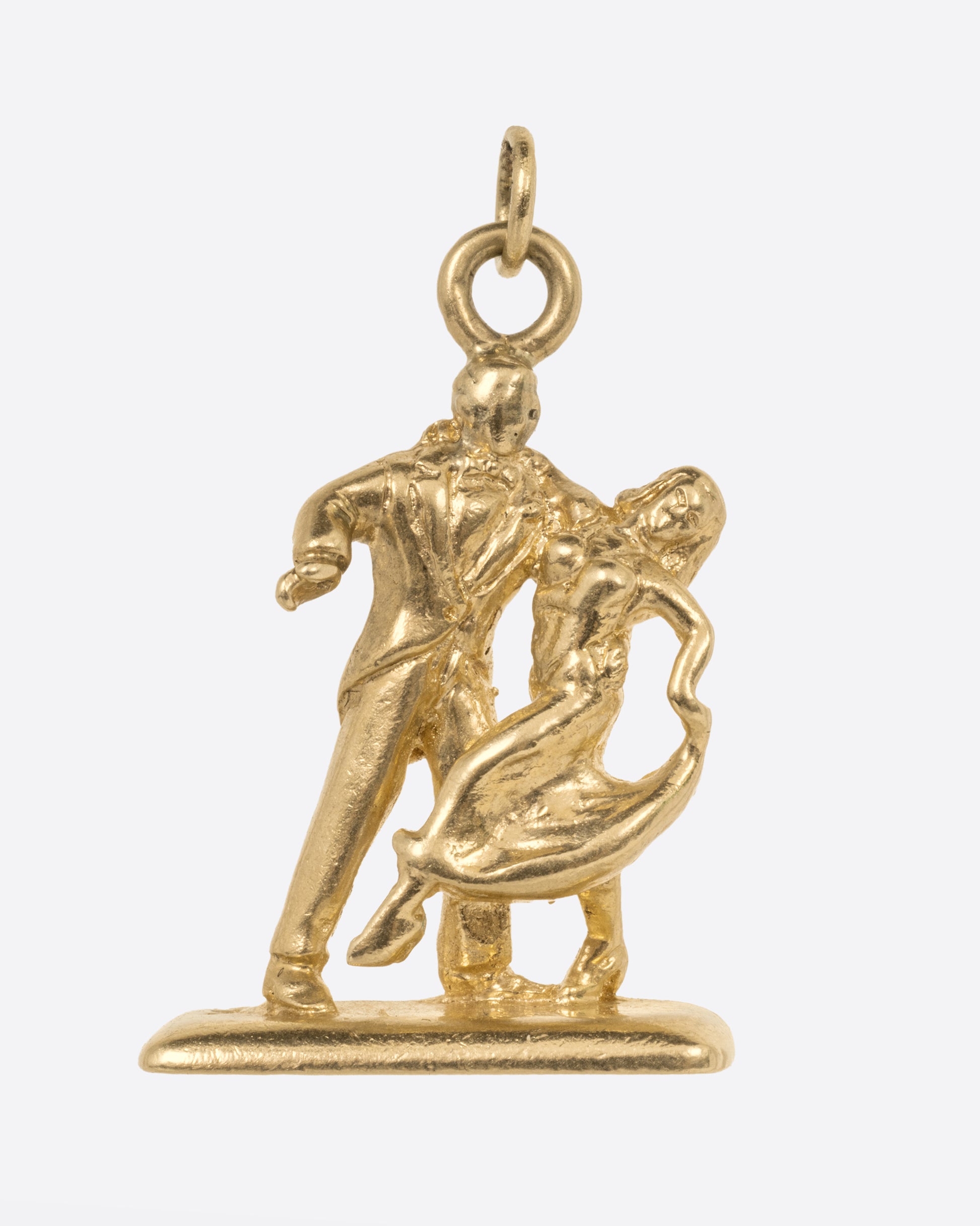 A yellow gold charm with  dancing couple, shown from the front.