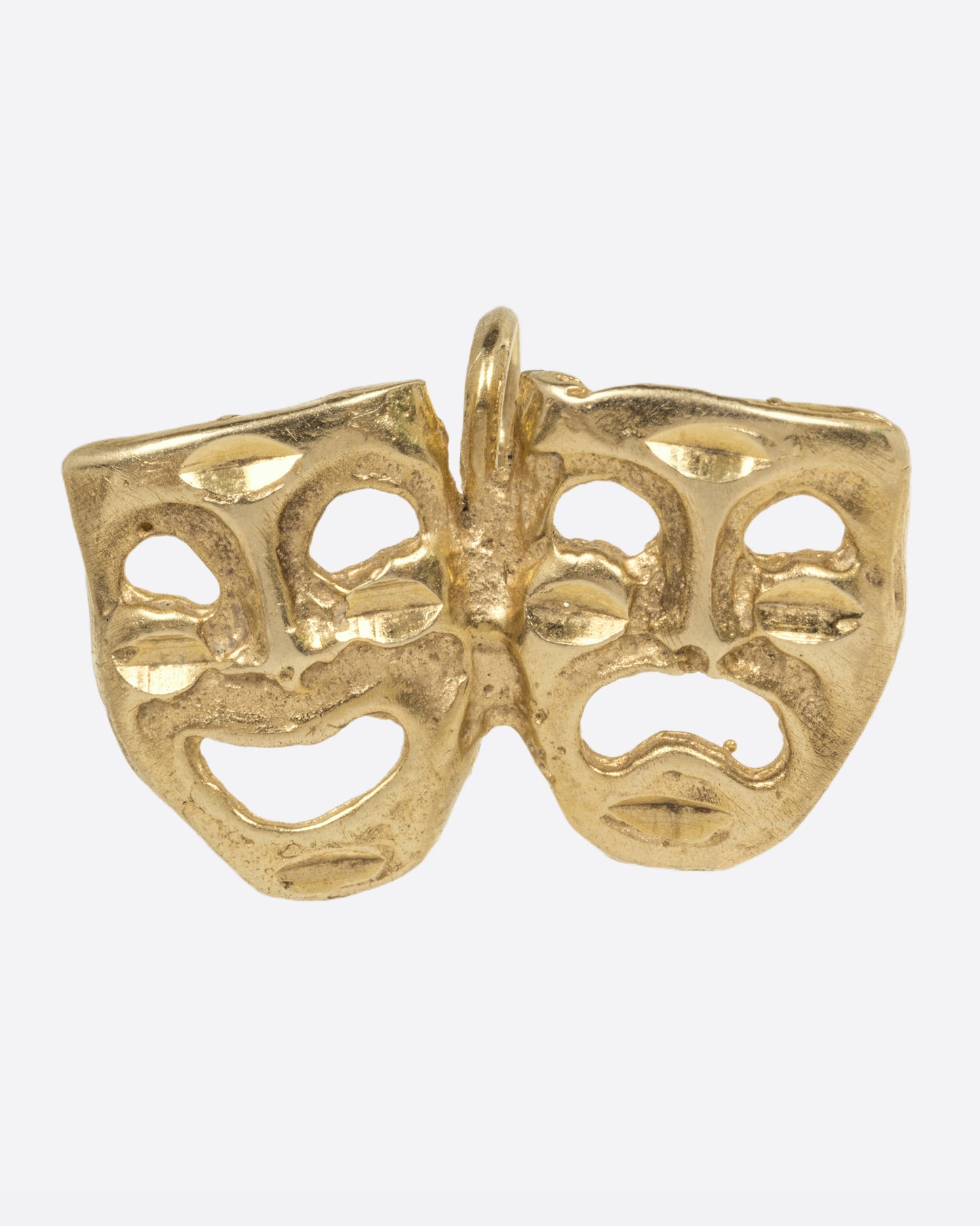 A yellow gold theatrical mask charm, with one smiling, and one frowning. Show from the front.