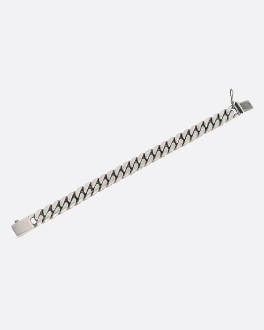 A silver curb chain bracelet, shown open from the front.