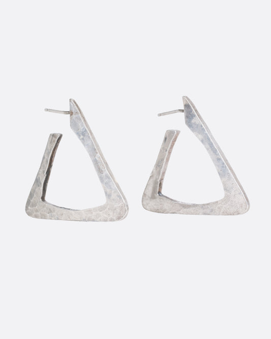 A pair of silver triangular hoop earrings, shown from the side.