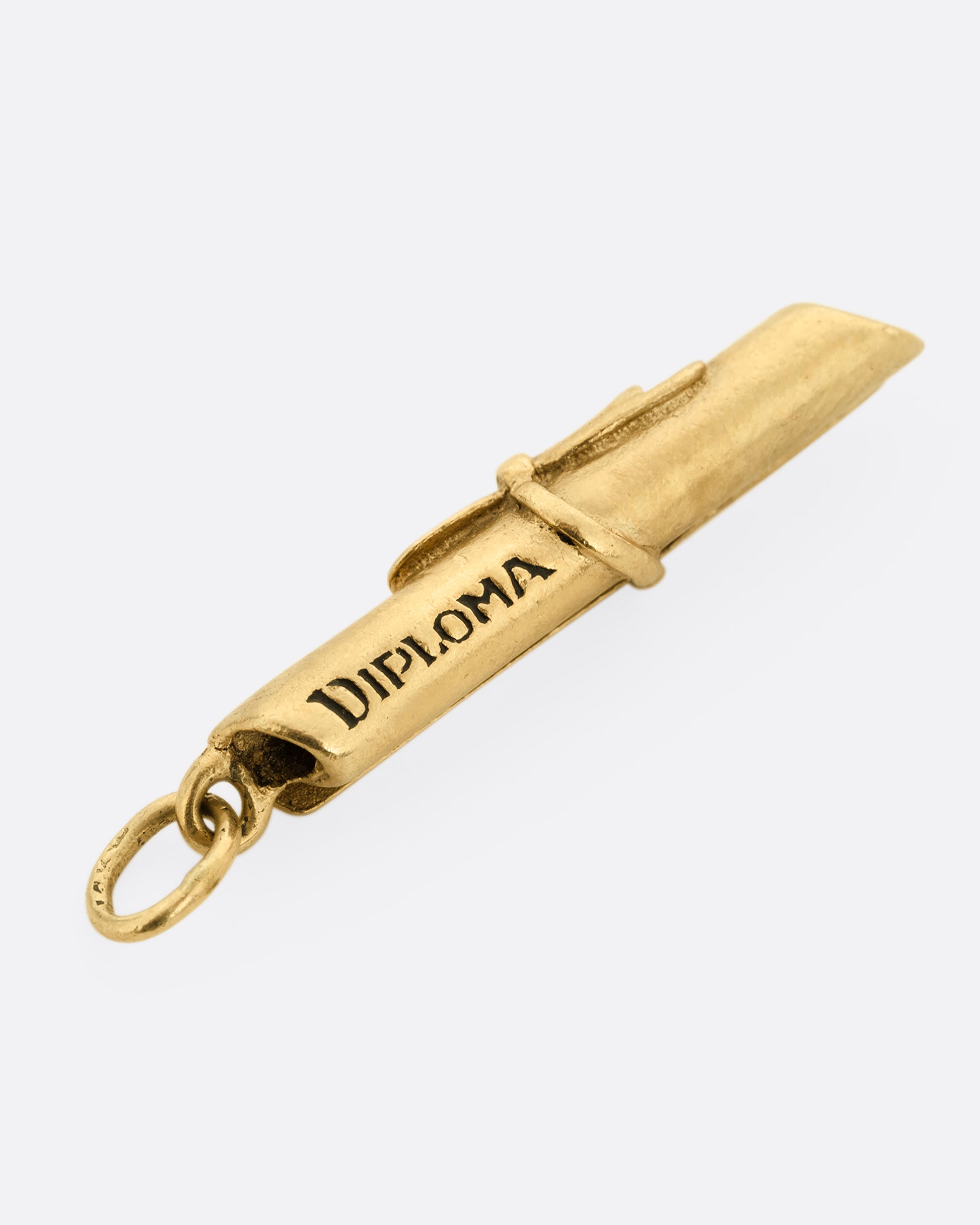 A yellow gold scroll tied with ribbon with 'Diploma' engraved on its side. Shown lying flat from the top.