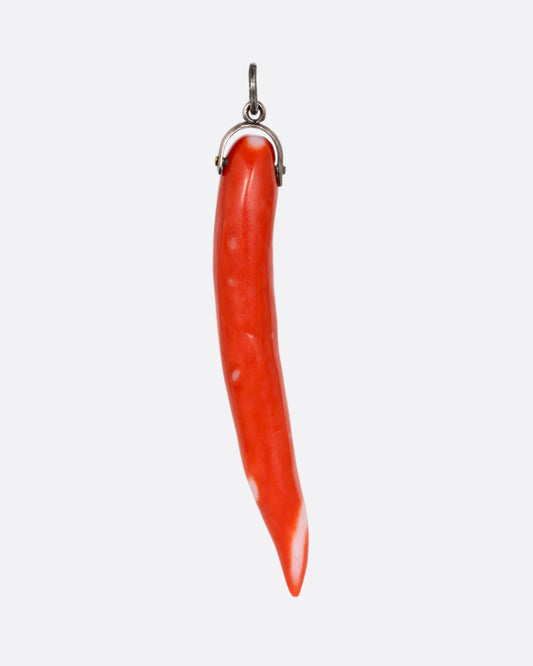 A coral branch charm on a silver bail. Shown from the front.