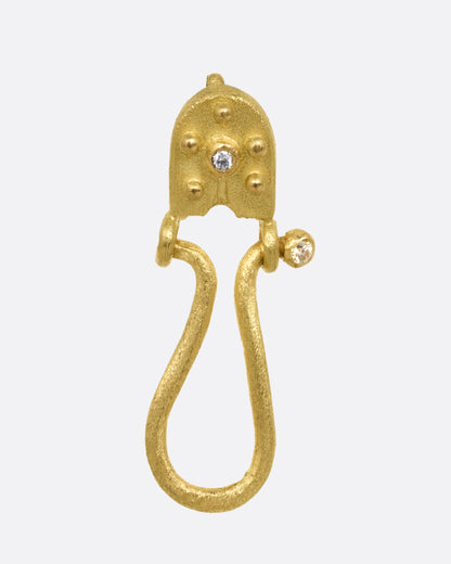 Lene Vibe charm holder pendant in 18k yellow gold, a textured hook with granulation and a diamond accent