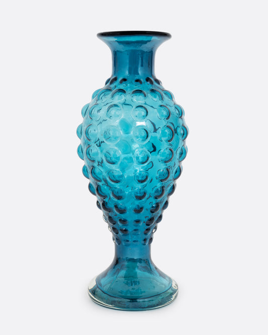 A teal hourglass glass vase with a bubbled texture. Shown from the front.