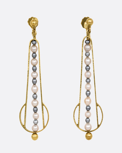 Yellow gold geometric dangle earrings with screw clasps and pearls down the center. Shown from the front.