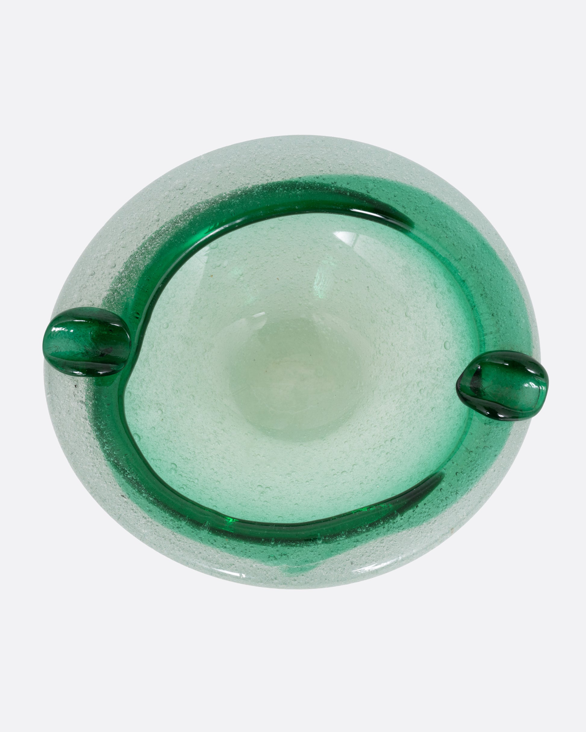 A green blown glass ashtray, shown from the top.