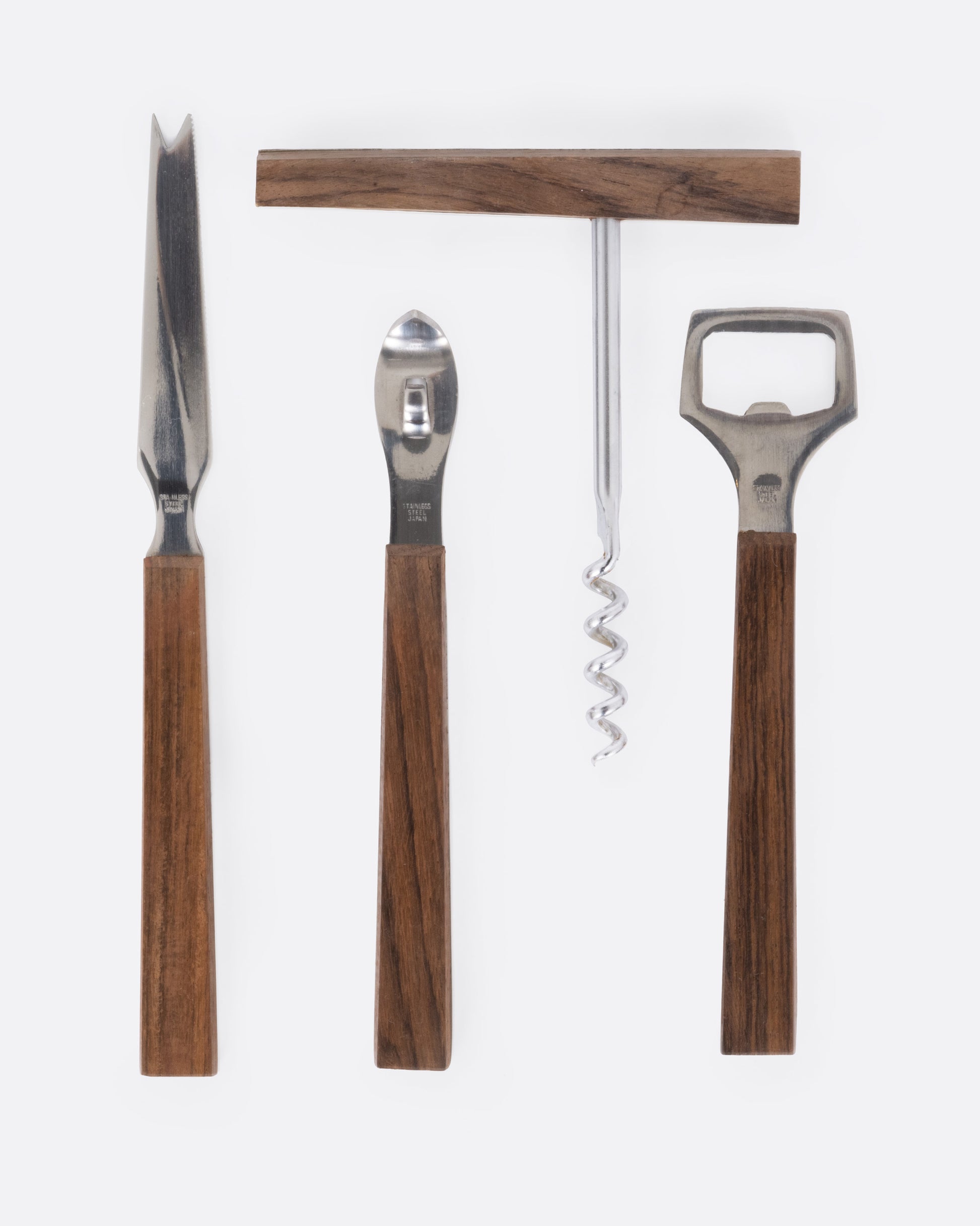 A four piece stainless steel bar set with wooden handles. The pieces are shown lined up lying flat.