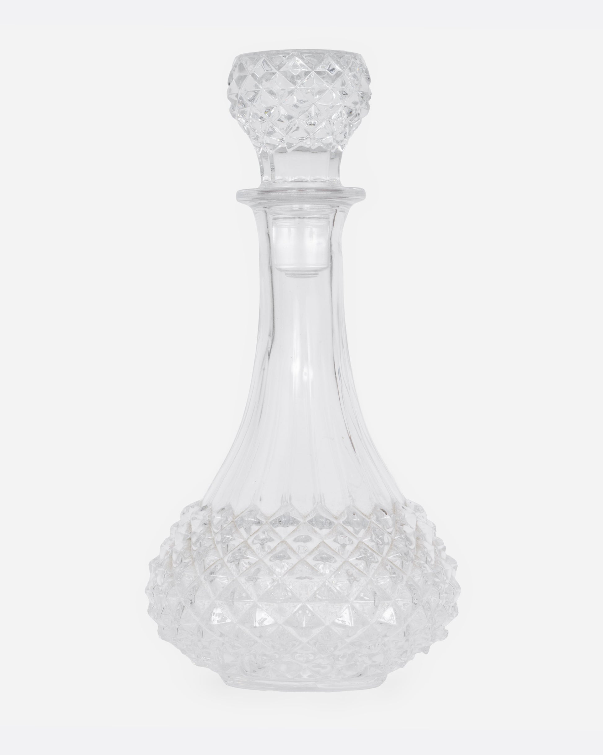 A crystal cut glass decanter, shown from the front.