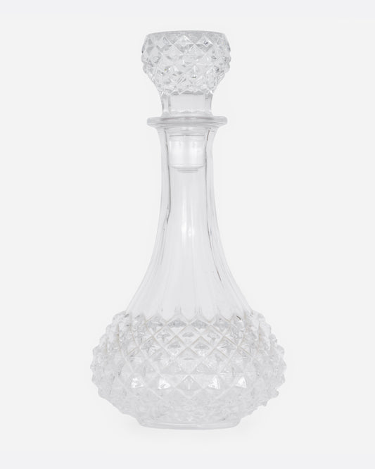 A crystal cut glass decanter, shown from the front.