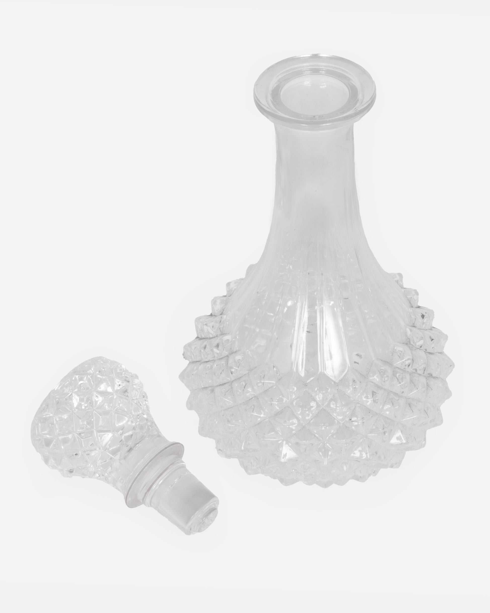 A crystal cut glass decanter, shown from the top open.