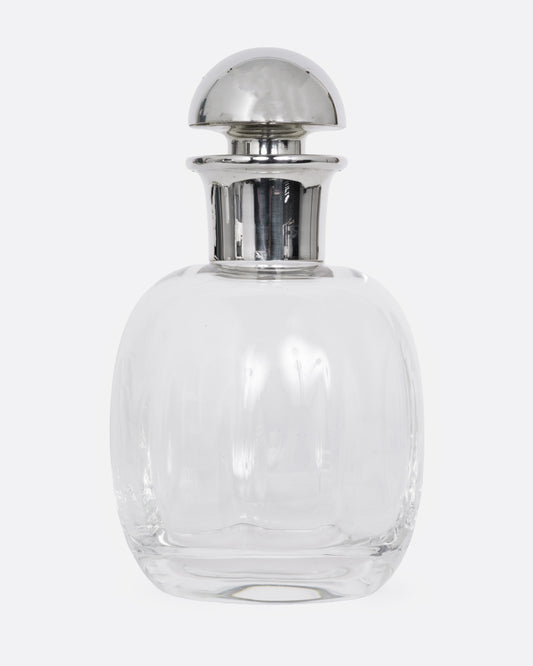 A clear glass decanter with a silver top, shown from the front.