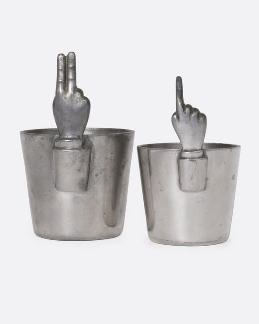 Two silver cups with hand-shaped handles, shown from the front.
