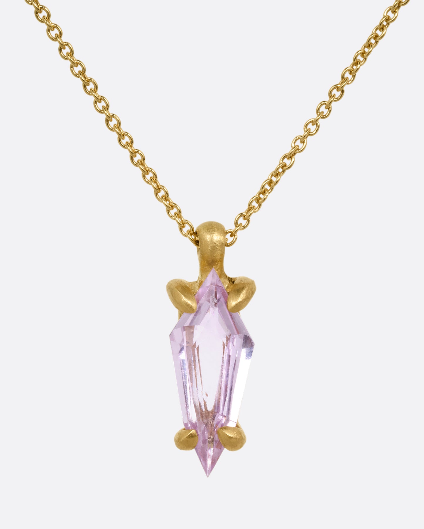A yellow gold cable chain necklace with a single pink sapphire pendant. Shown from the front.