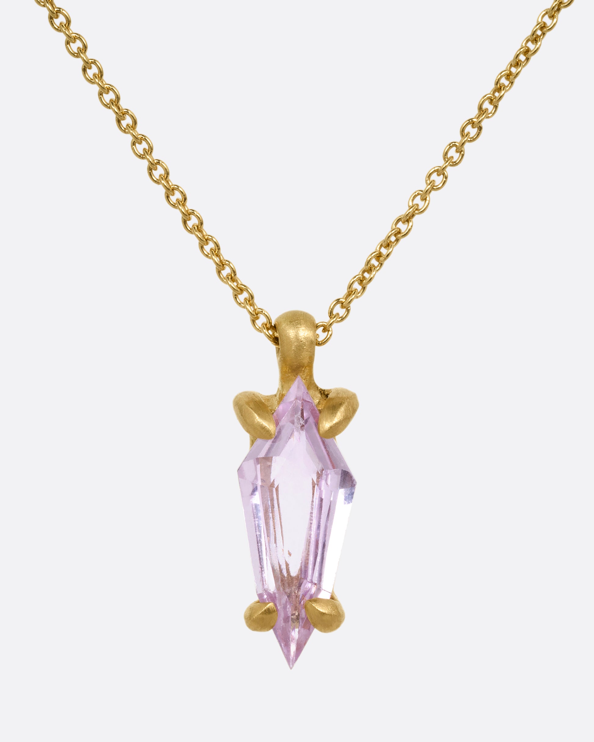 A yellow gold cable chain necklace with a single pink sapphire pendant. Shown from the front.