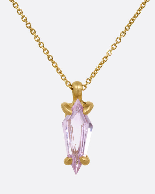A yellow gold cable chain necklace with a single pink sapphire pendant. Shown from the front.