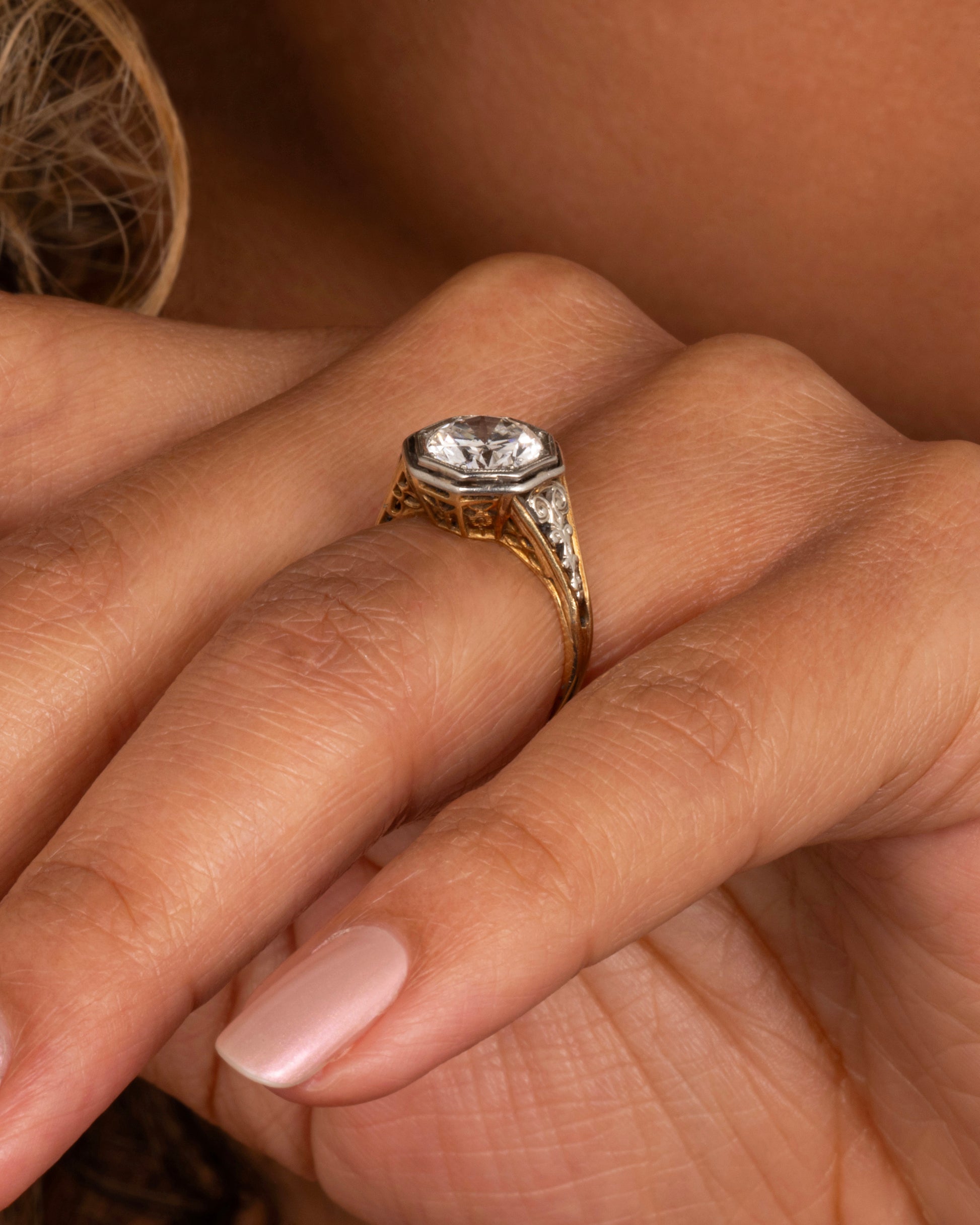 Mixed metals, intricate setting, large diamond; the ultimate vintage engagement ring.