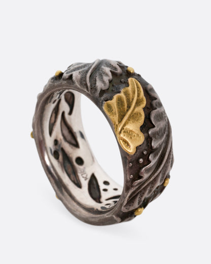 Platinum and gold acanthus leaf band, angled view showing the gold leaf and the pierced inside of the band