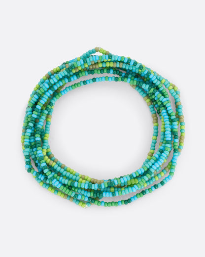 Stone and Paper stretchy seed bead bracelets in blue, green and turquoise, shown as a stack